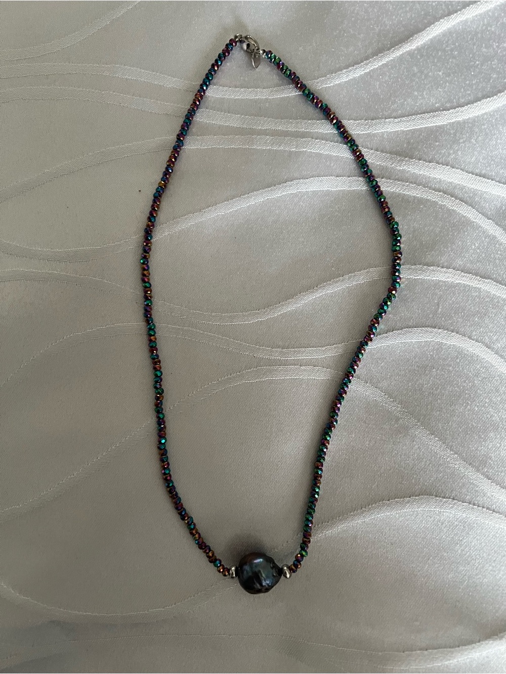 Beautiful luminous fresh water pearl with a string of colorful glass beads.